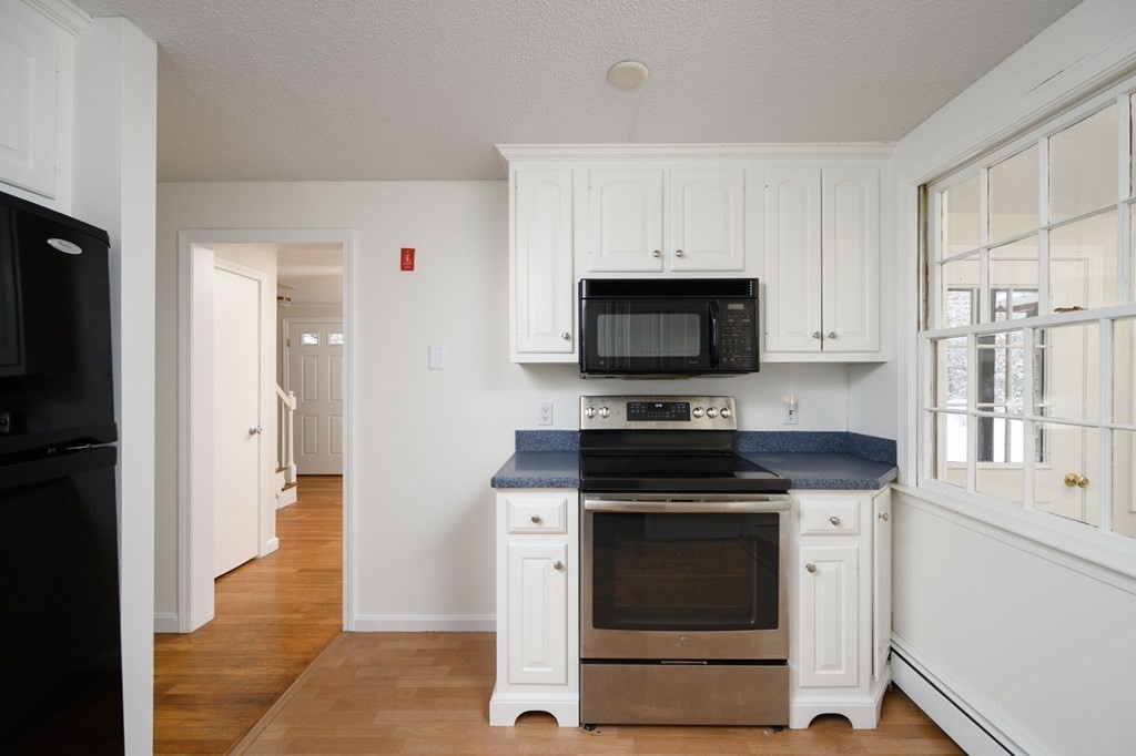 571 Main Street Marshfield, MA 02050 - Photo 8 of 25 a kitchen with granite countertop white cabinets and stainless steel appliances