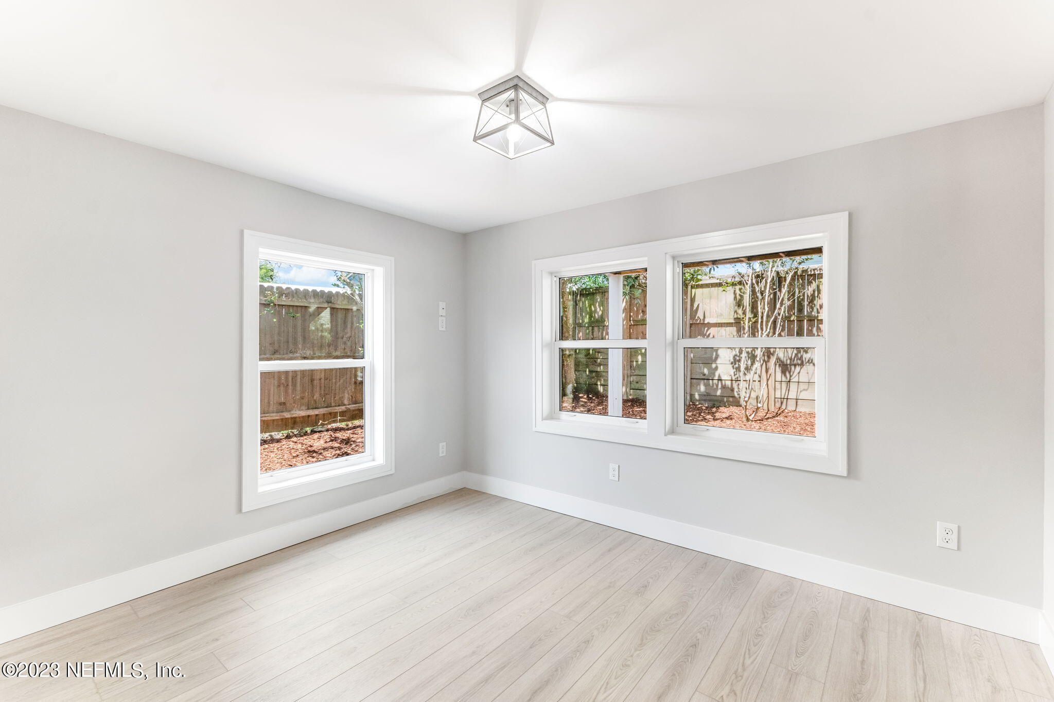 5348 Pelican Way St. Augustine, FL 32080 - Photo 16 of 58 an empty room with wooden floor and windows