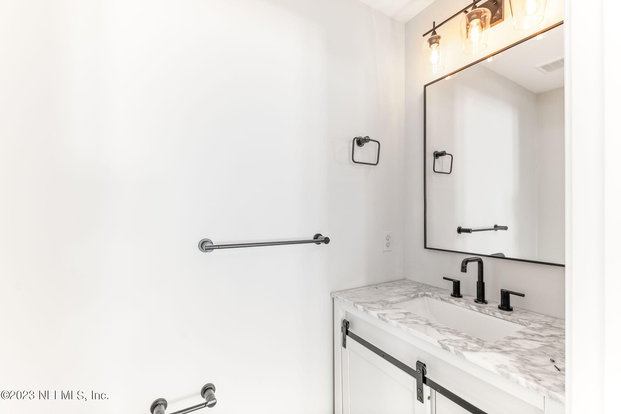 5348 Pelican Way St. Augustine, FL 32080 - Photo 23 of 58 a bathroom with a granite countertop sink and a mirror