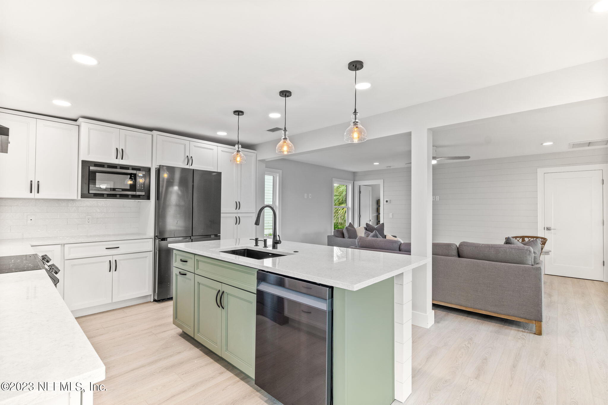 5348 Pelican Way St. Augustine, FL 32080 - Photo 29 of 58 a kitchen with stainless steel appliances kitchen island granite countertop a sink and refrigerator
