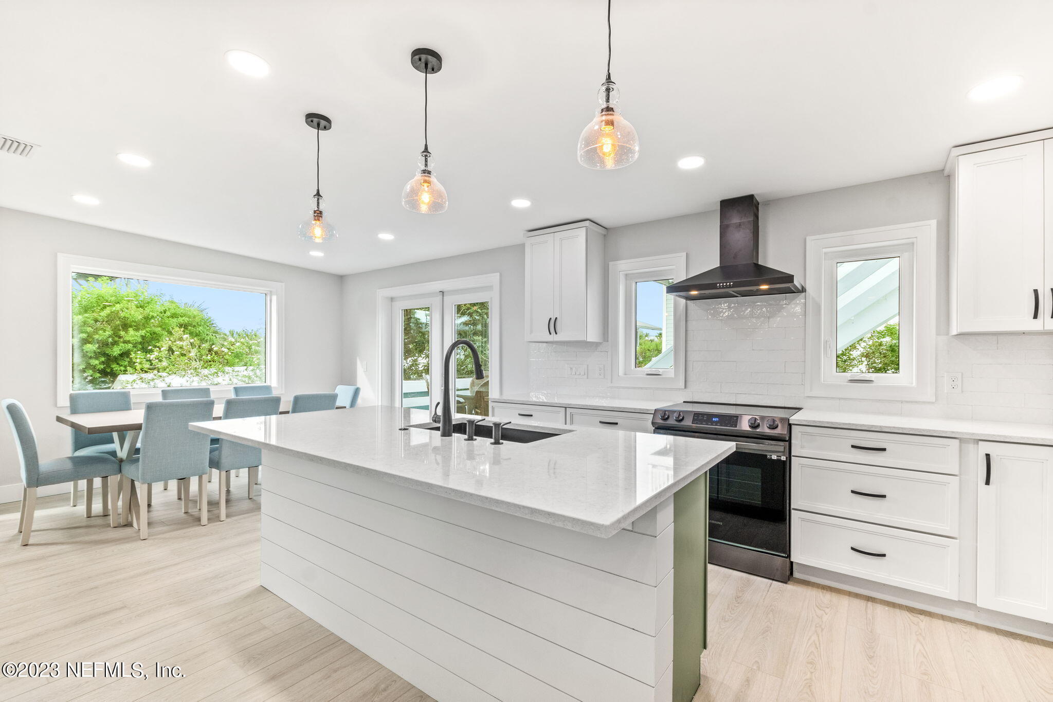 5348 Pelican Way St. Augustine, FL 32080 - Photo 30 of 58 a kitchen with stainless steel appliances granite countertop a sink a stove and a wooden floors