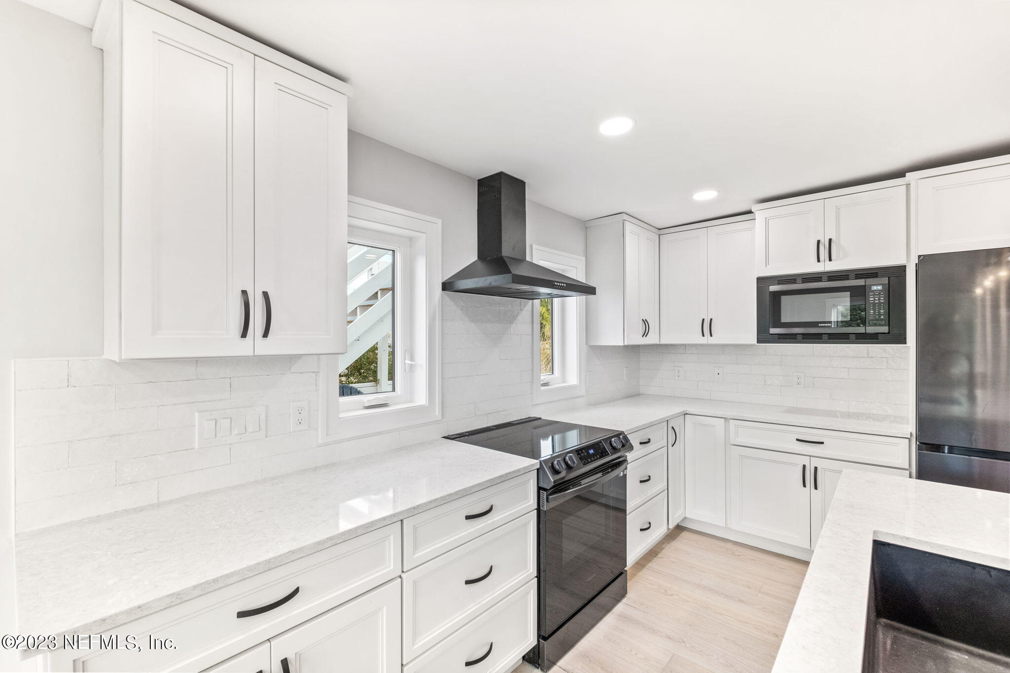5348 Pelican Way St. Augustine, FL 32080 - Photo 33 of 58 a kitchen with granite countertop white cabinets and stainless steel appliances