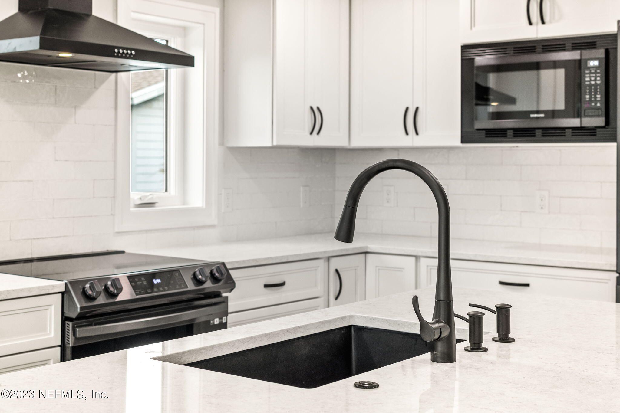 5348 Pelican Way St. Augustine, FL 32080 - Photo 35 of 58 a kitchen with a stove and a white cabinet