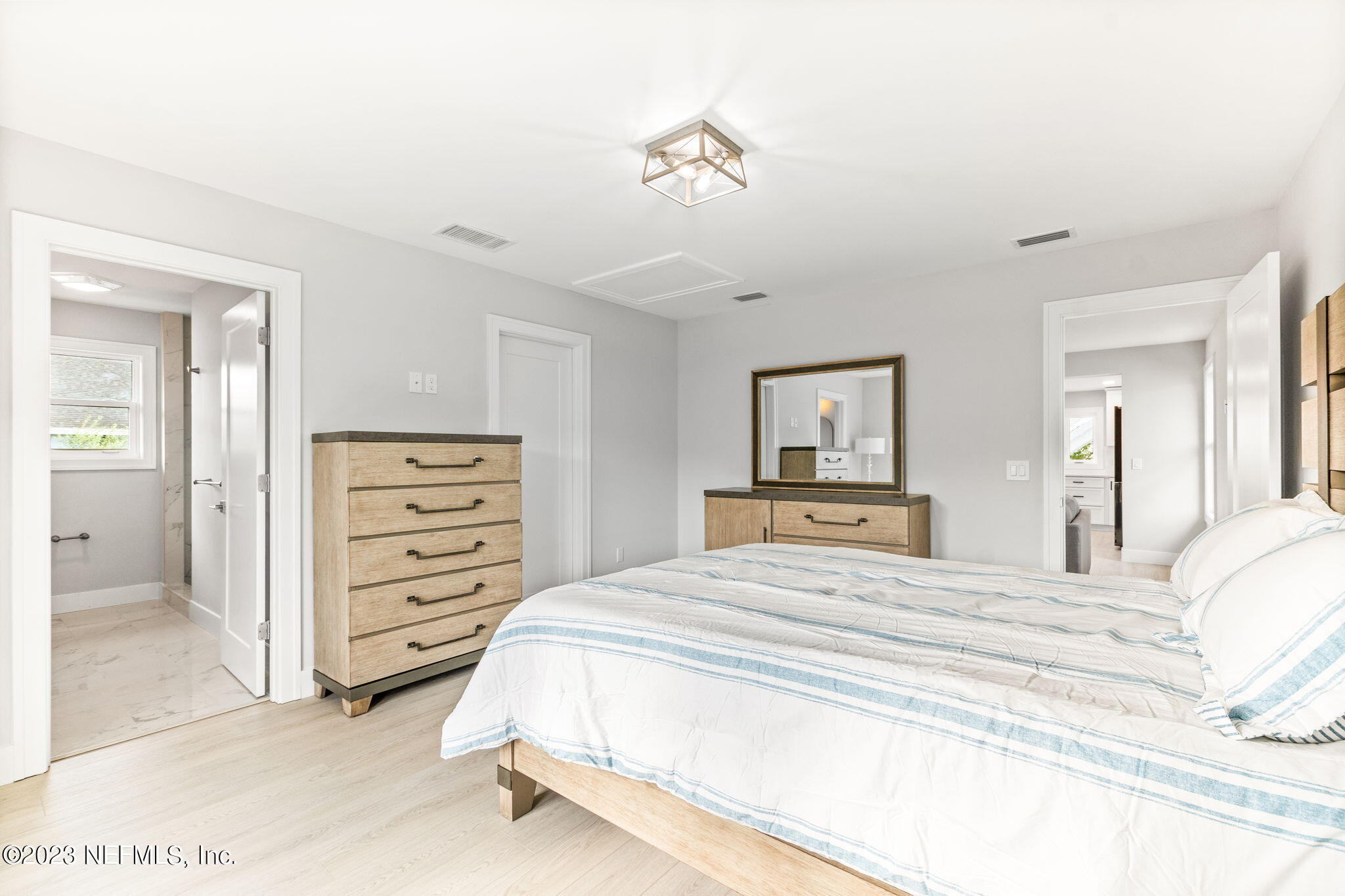 5348 Pelican Way St. Augustine, FL 32080 - Photo 39 of 58 a bedroom with a bed and a chandelier