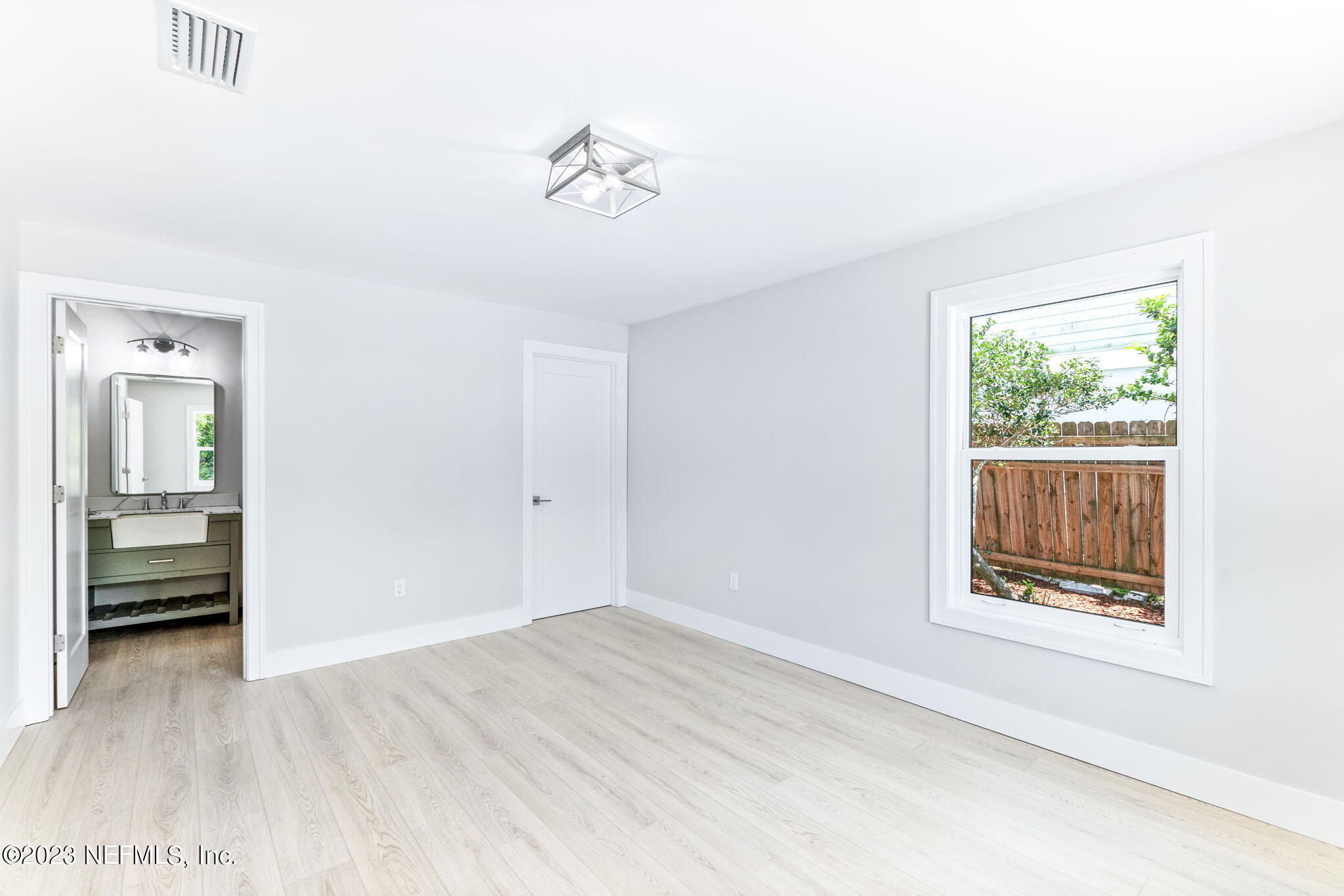 5348 Pelican Way St. Augustine, FL 32080 - Photo 6 of 58 a view of an empty room with wooden floor and a window