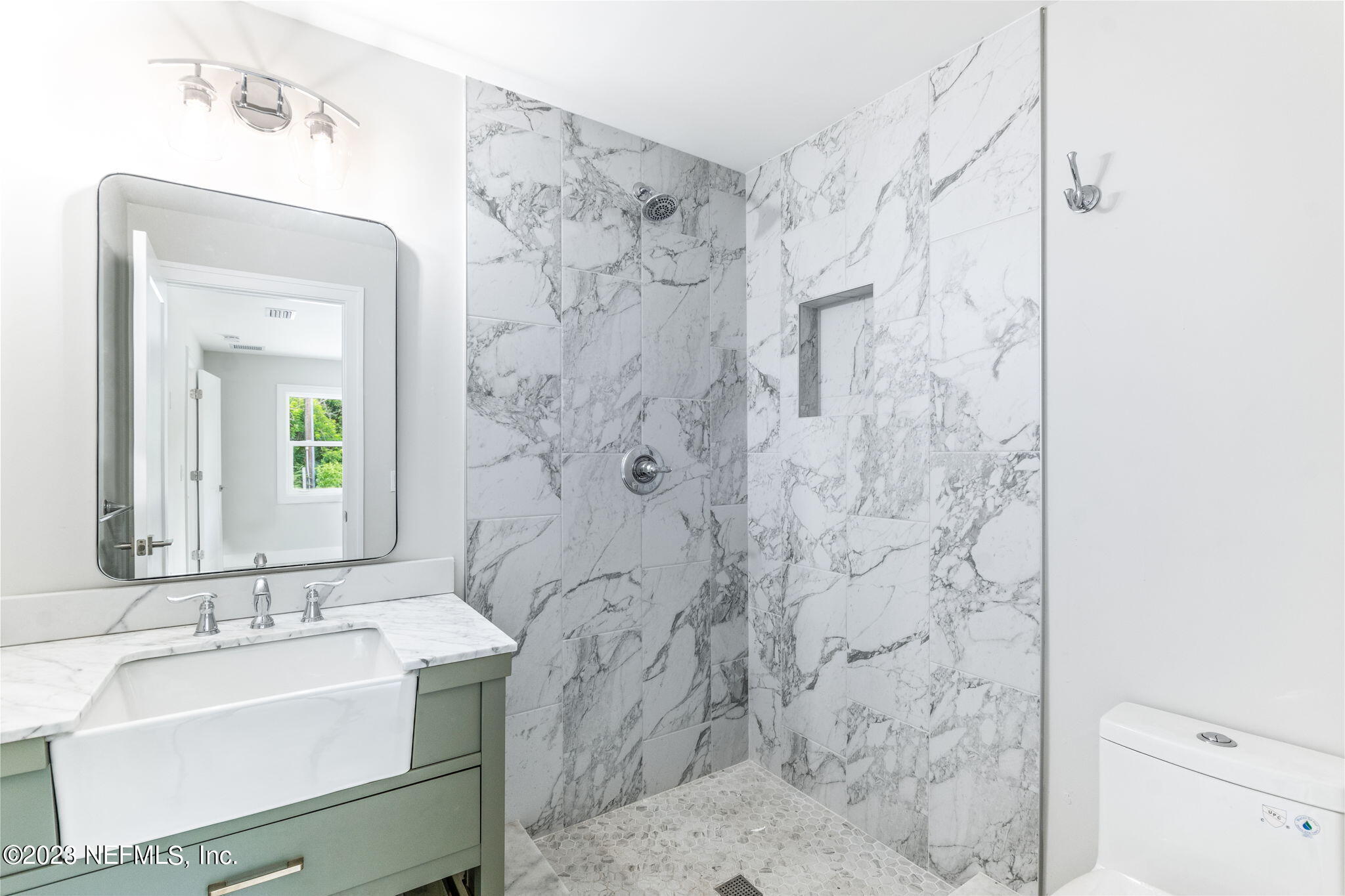 5348 Pelican Way St. Augustine, FL 32080 - Photo 8 of 58 a bathroom with a sink mirror and shower