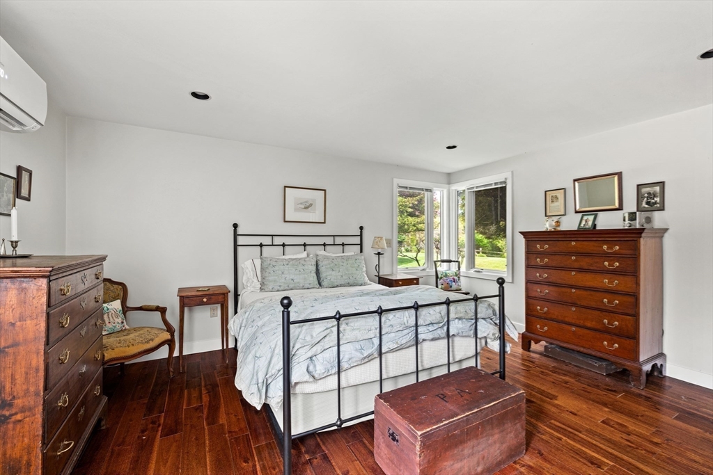 103 Howland Road Westport, MA 02790 - Photo 17 of 35 a bedroom with a bed and wooden floor