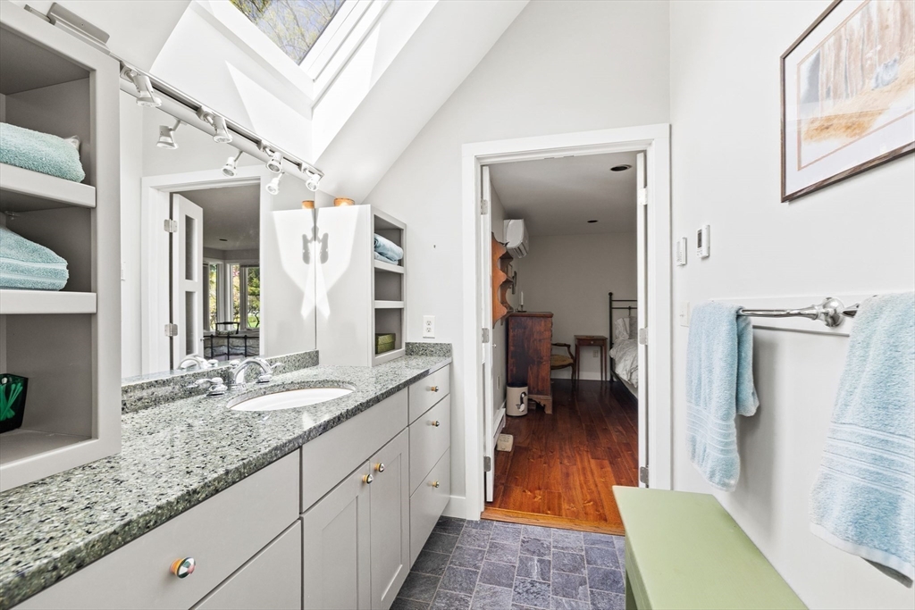 103 Howland Road Westport, MA 02790 - Photo 19 of 35 a en suite bathroom with a granite countertop sink and a mirror
