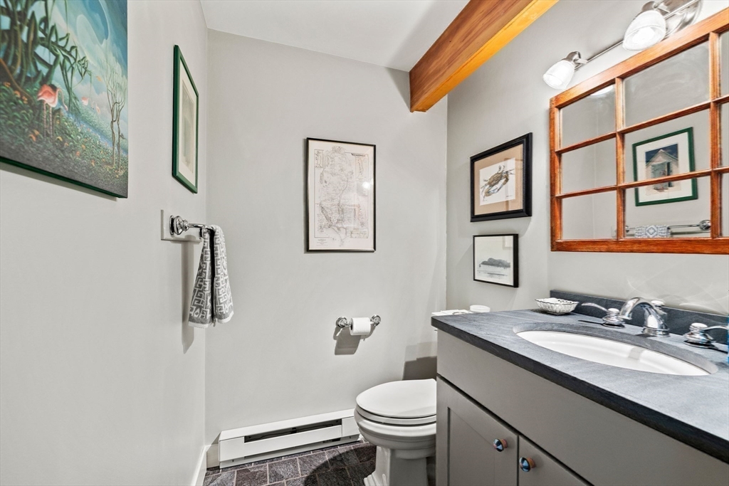 103 Howland Road Westport, MA 02790 - Photo 26 of 35 a bathroom with a granite countertop toilet sink and mirror