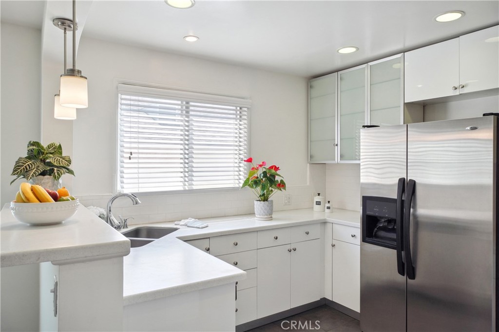 11767 Sunset Boulevard, Unit 202 Los Angeles, CA 90049 - Photo 12 of 22 a kitchen with a sink a counter appliances and cabinets
