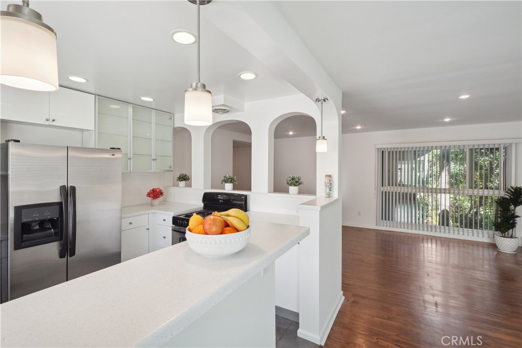 11767 Sunset Boulevard, Unit 202 Los Angeles, CA 90049 - Photo 14 of 22 a large kitchen with sink a refrigerator and wooden floor