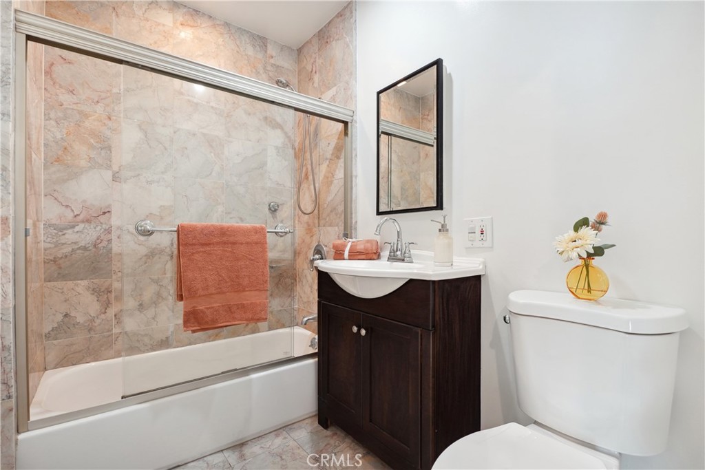 11767 Sunset Boulevard, Unit 202 Los Angeles, CA 90049 - Photo 17 of 22 a bathroom with a sink toilet and shower