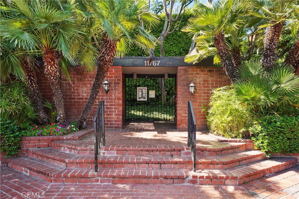 11767 Sunset Boulevard, Unit 202 Los Angeles, CA 90049 - Photo 2 of 22 a front view of a house with a tree