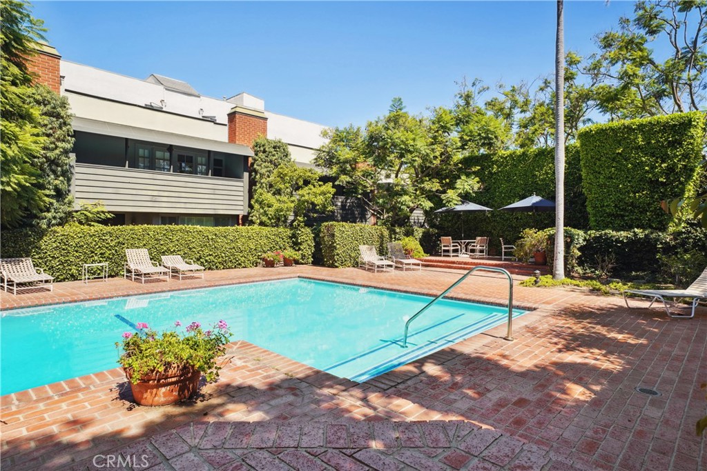 11767 Sunset Boulevard, Unit 202 Los Angeles, CA 90049 - Photo 21 of 22 a view of a swimming pool with a lounge chairs
