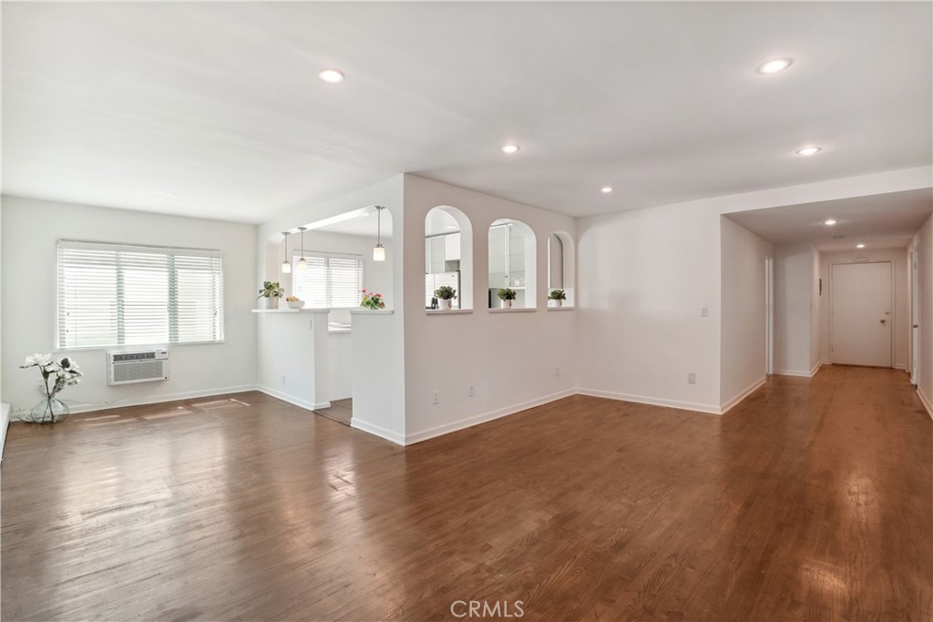 11767 Sunset Boulevard, Unit 202 Los Angeles, CA 90049 - Photo 8 of 22 a view of a big room with wooden floor and windows