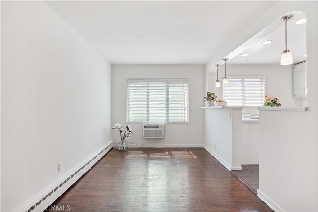 11767 Sunset Boulevard, Unit 202 Los Angeles, CA 90049 - Photo 9 of 22 wooden floor in an empty room with a window