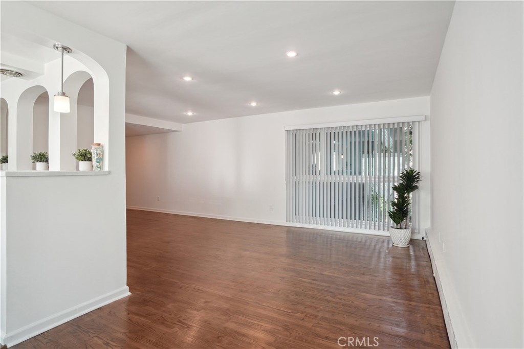11767 Sunset Boulevard, Unit 202 Los Angeles, CA 90049 - Photo 10 of 22 a view of an empty room with wooden floor and a window