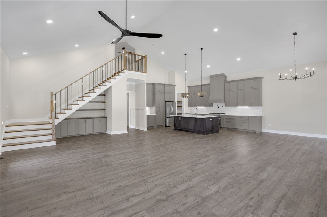 384 Jim Smith Road Pendleton, SC 29670 - Photo 47 of 48 An open floorplan with vaulted ceilings and wood-look flooring connects the living area and kitchen.