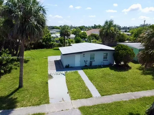 a view of a house with garden and a patio