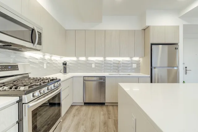 a kitchen with a stove a sink and a refrigerator
