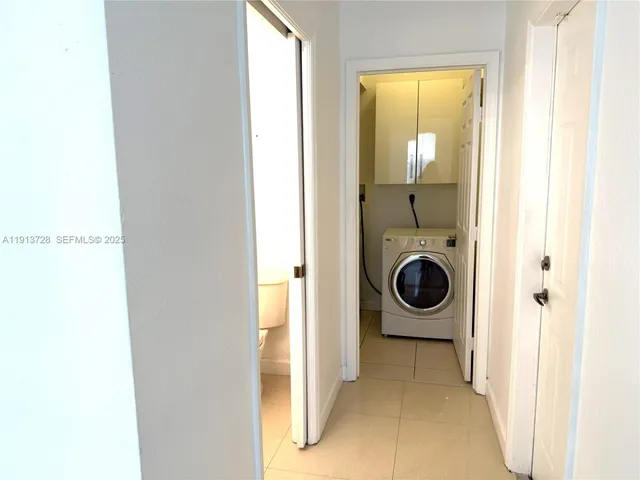 a view of a hallway with washer and dryer