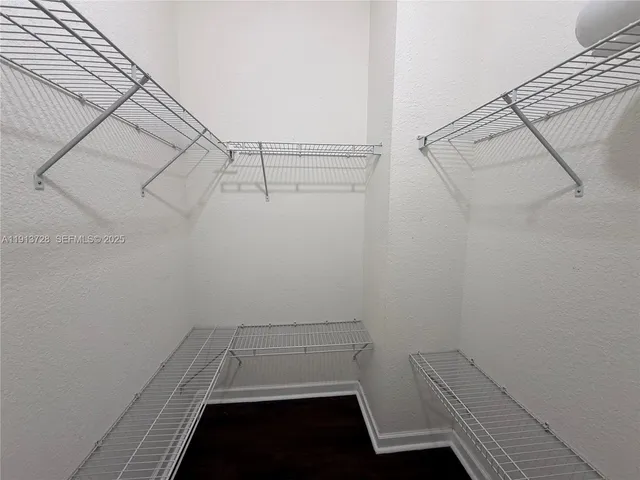 a view of storage and utility room with racks on the wall