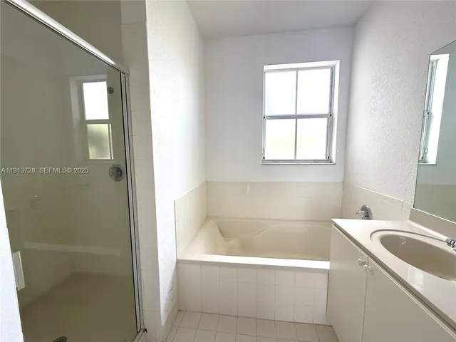 a bathroom with a bathtub and a sink