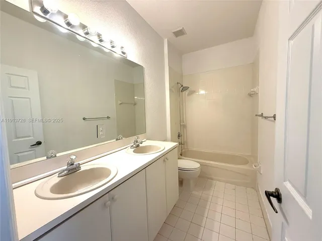 a bathroom with a sink double vanity and a shower