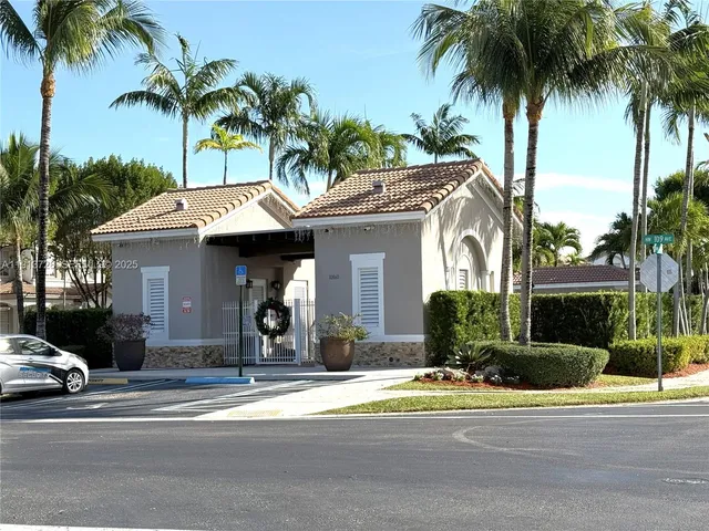 a view of street with houses and palm trees