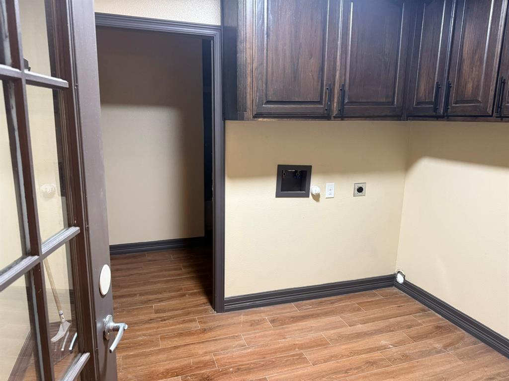 3307 Roberts Cut Off Road Lake Worth, TX 76135 - Photo 11 of 14 an empty room with wooden floor and cabinets