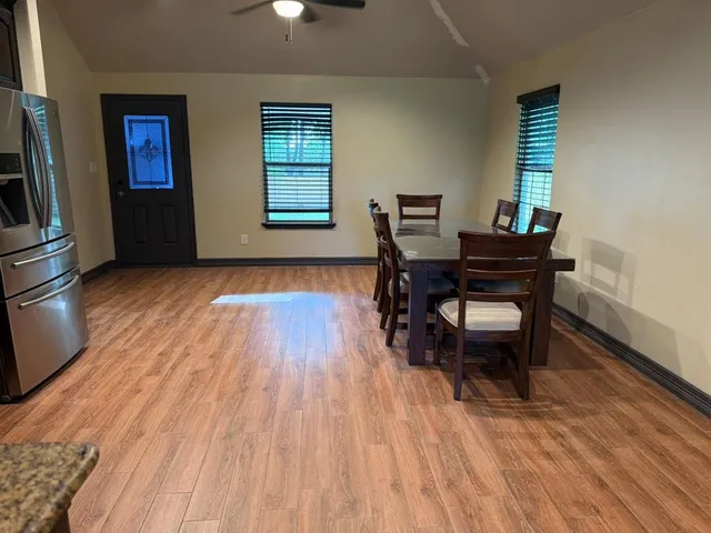 a workspace room with furniture and wooden floor