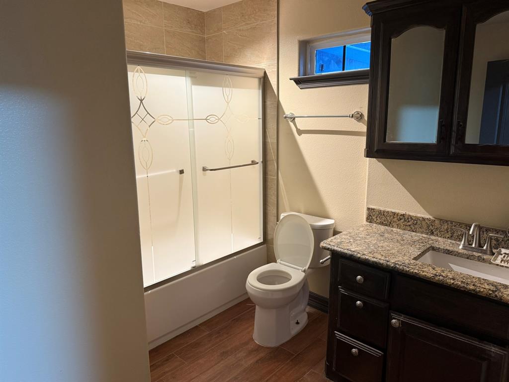 3307 Roberts Cut Off Road Lake Worth, TX 76135 - Photo 7 of 14 a bathroom with a granite countertop sink toilet and mirror