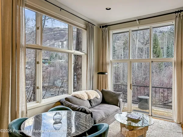 a living room with furniture and a floor to ceiling window