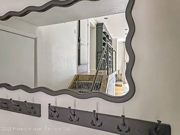 a bedroom with a bed a painting on the wall and a large window