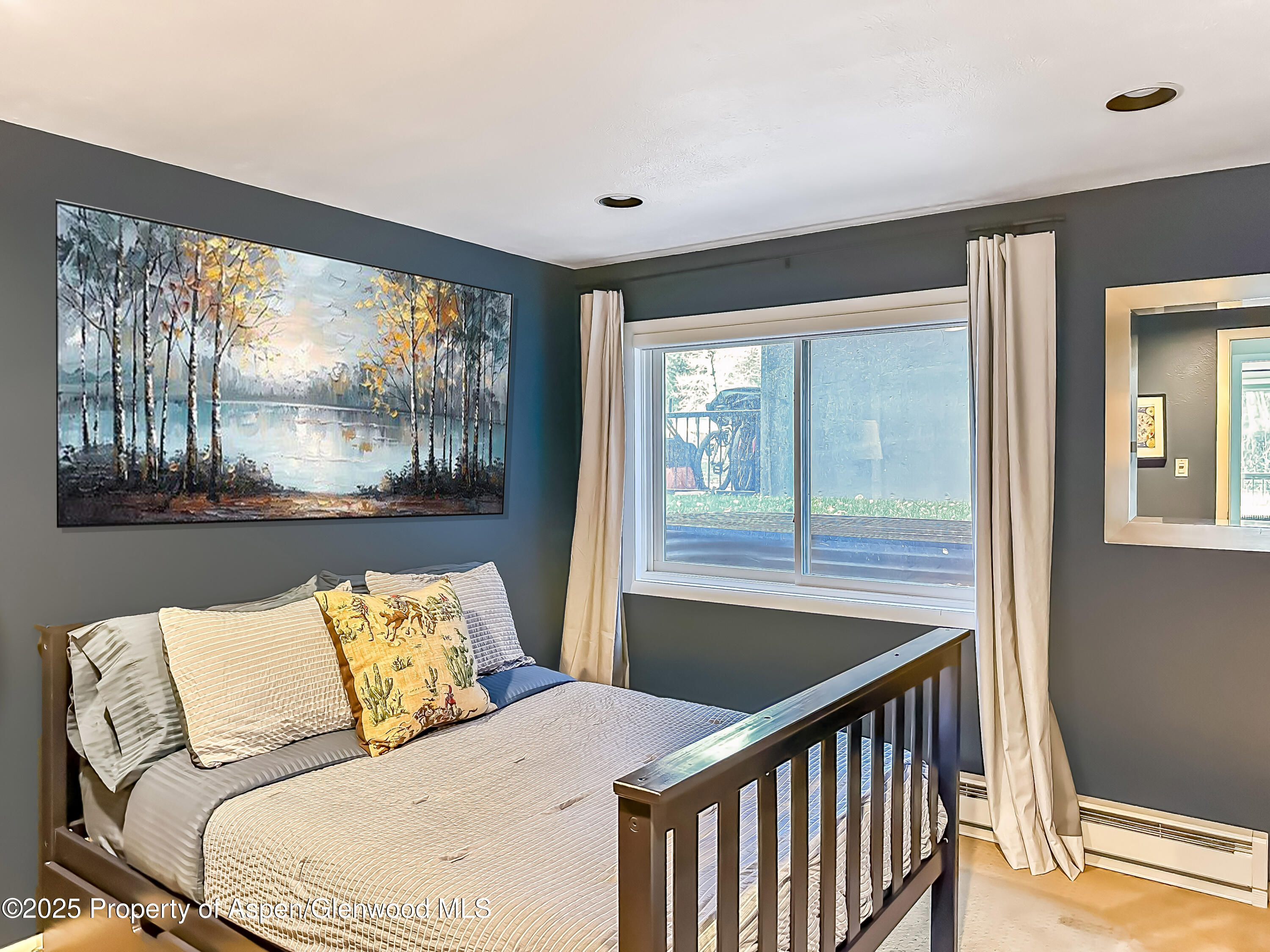 1050 Waters Avenue, Unit 9 Aspen, CO 81611 - Photo 14 of 19 a bedroom with a bed and a large window