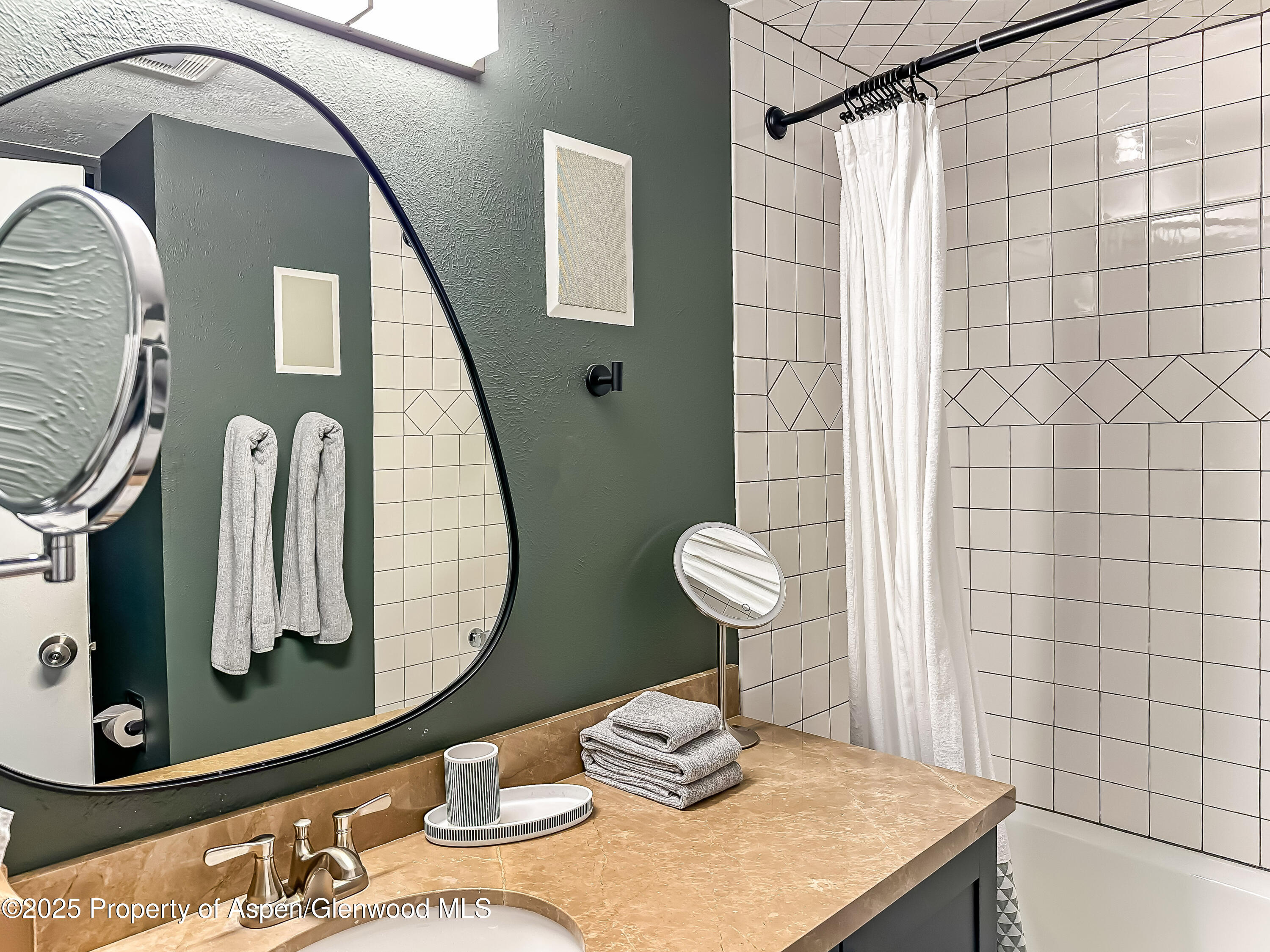 1050 Waters Avenue, Unit 9 Aspen, CO 81611 - Photo 16 of 19 a bathroom with a sink and a mirror