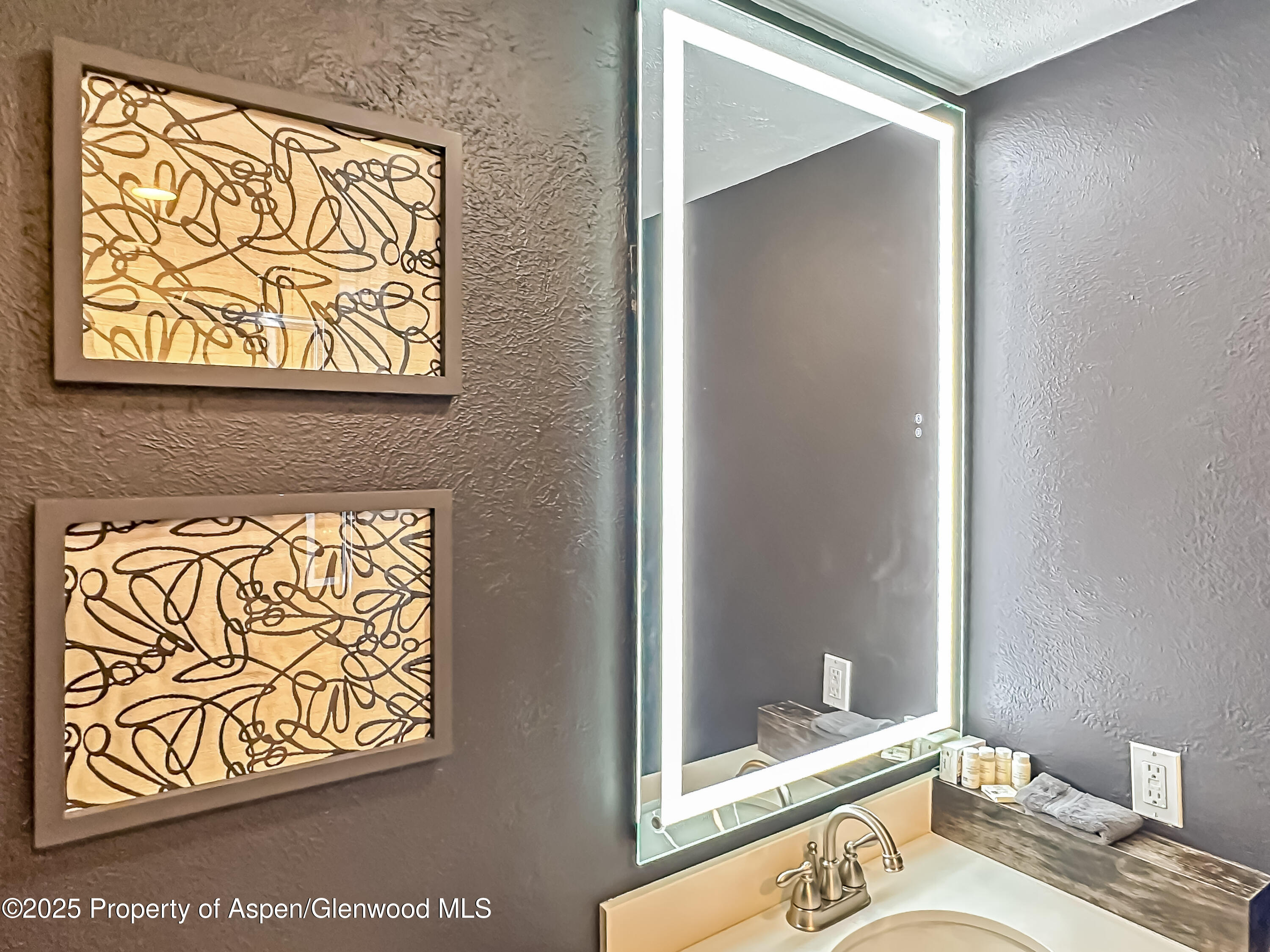 1050 Waters Avenue, Unit 9 Aspen, CO 81611 - Photo 17 of 19 a bathroom with a granite countertop sink and a mirror