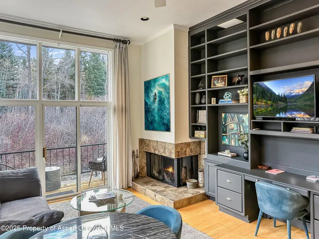 a living room with furniture a window and a fireplace
