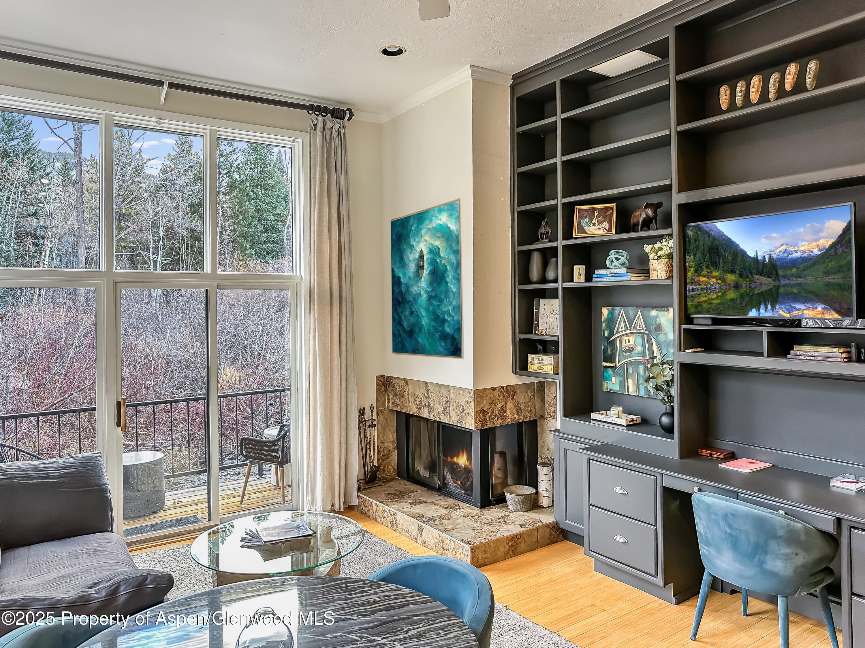 1050 Waters Avenue, Unit 9 Aspen, CO 81611 - Photo 2 of 19 a living room with furniture a window and a fireplace