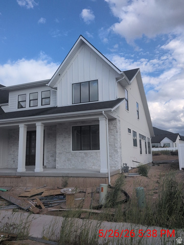 2771 West Aurora Avenue Mapleton, UT 84664 - Photo 36 of 39 Modern farmhouse-style exterior featuring board and batten siding and stone accents