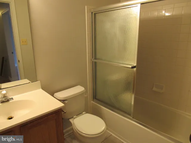a bathroom with a glass shower door