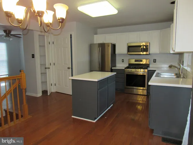 a kitchen with stainless steel appliances granite countertop a refrigerator a stove a sink and dishwasher
