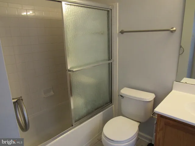 a view of a room with wooden floor and fan