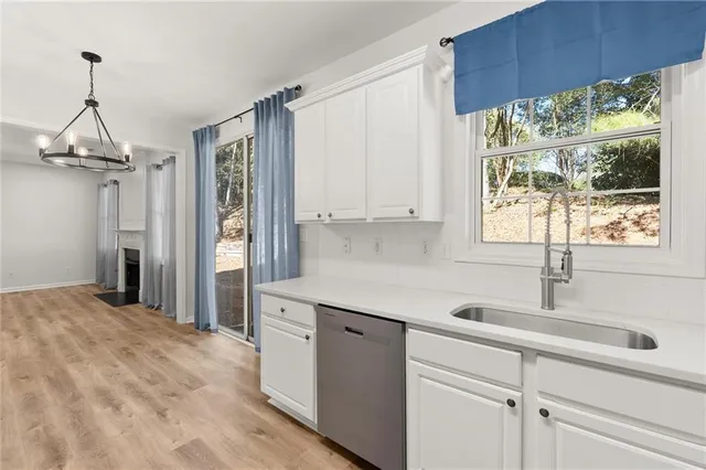 a kitchen with a sink window and cabinets