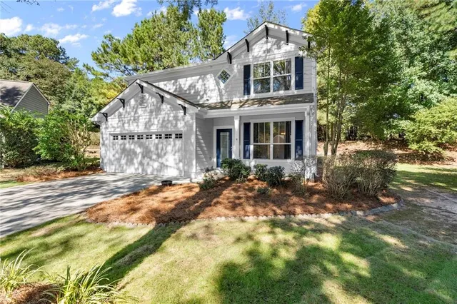 a front view of a house with a garden