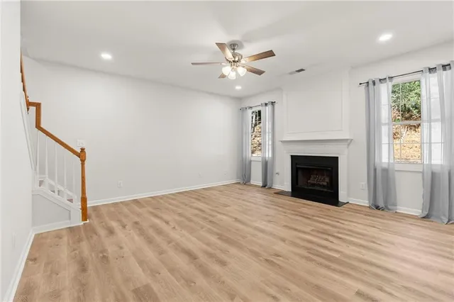 a view of empty room with a fireplace and fan