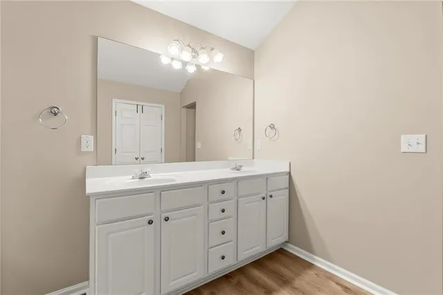 a spacious bathroom with a double vanity sink and mirror
