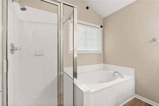 a white bath tub sitting next to a shower