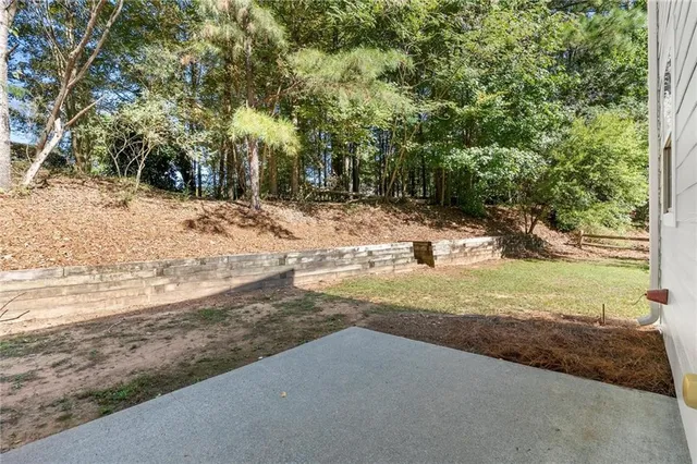 a view of a yard with large trees