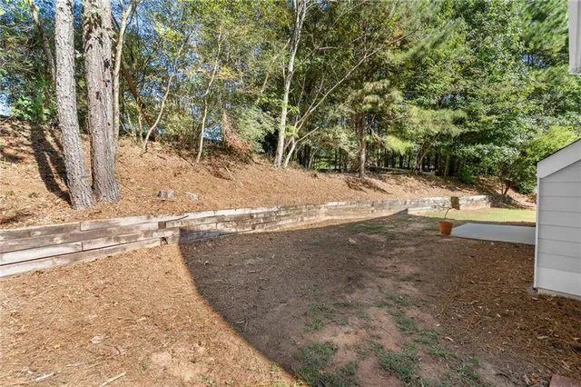 a view of a yard with large trees